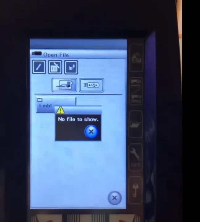 The embroidery machine screen showing a "No file to show" error when opening a design folder