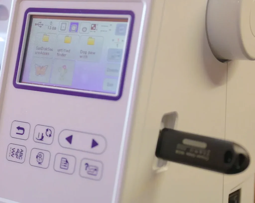 Loading embroidery designs onto an embroidery machine.